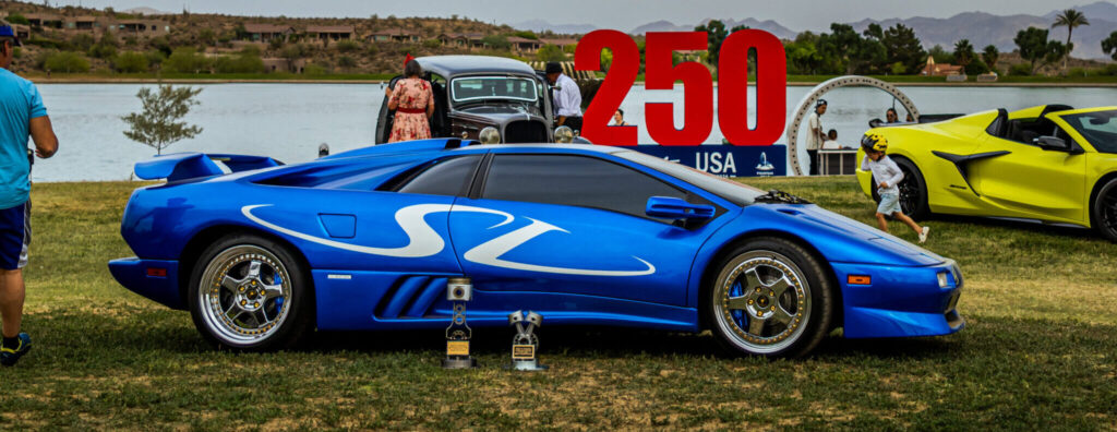 Arizona Cars and Coffee header image with blue Lamborghini Diablo SV at Best of Arizona Cars and Coffee on the grass at Fountain Park in Fountain Hills, AZ